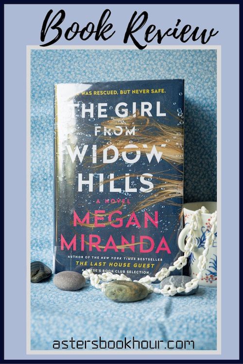 The pinterest image for The Girl From Widow Hills by Megan Miranda book review. There is a blue floral print background with the novel centered in the middle and the cover facing the front. The words book review are in fake cursive over the top.