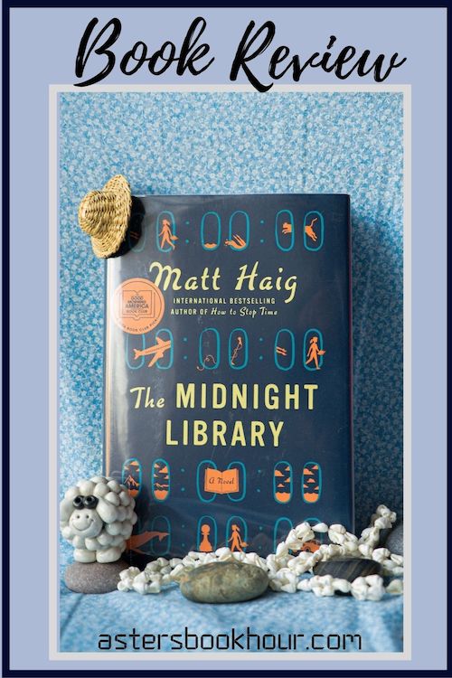 The pinterest image for The Midnight Library by Matt Haig book review. There is a blue floral print background with the novel centered in the middle and the cover facing the front.
