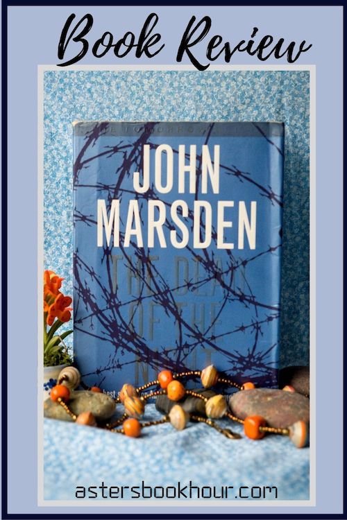 The pinterest image for The Dead of Night by John Marsden book review. There is a blue floral print background with the novel centered in the middle and the cover facing the front.
