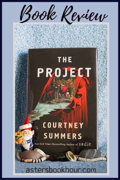 The pinterest image for The Project by Courtney Summers book review. There is a blue floral print background with the novel centered in the middle and the cover facing the front.