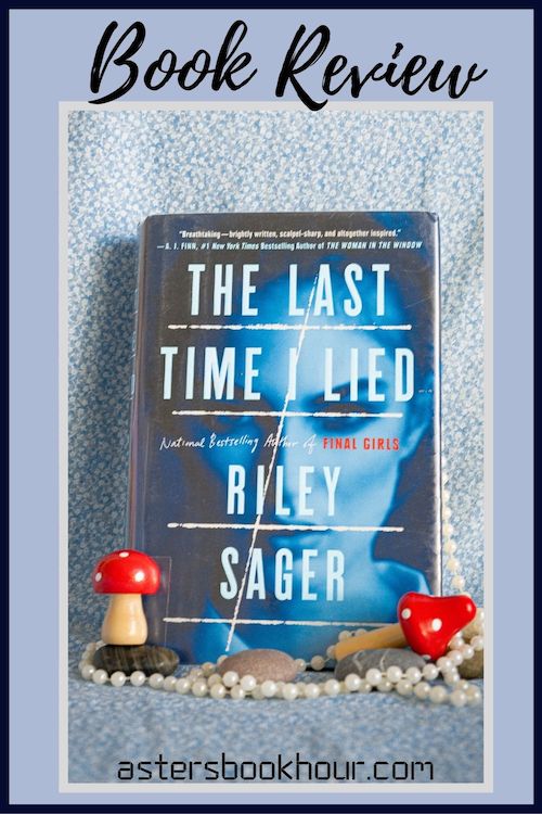 The pinterest image for The Last Time I Lied by Riley Sager book review. There is a blue floral print background with the novel centered in the middle and the cover facing the front.