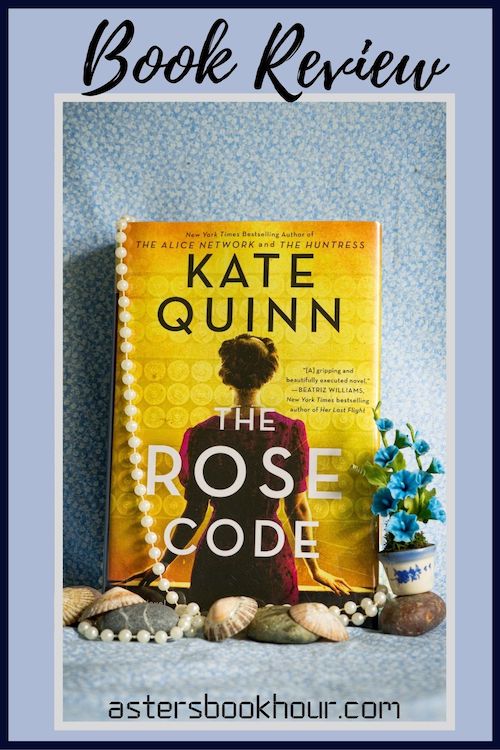 The pinterest image for The Rose Code by Kate Quinn book review. There is a blue floral print background with the novel centered in the middle and the cover facing the front.