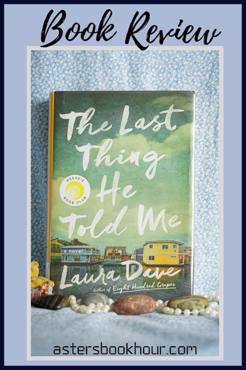 The pinterest image for The Last Thing He Told Me by Laura Dave book review. There is a blue floral print background with the novel centered in the middle and the cover facing the front.