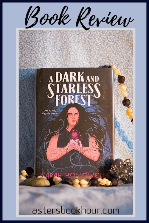 The pinterest image for A Dark and Starless Forest by Sarah Hollowell book review. There is a blue floral print background with the novel centered in the middle and the cover facing the front.