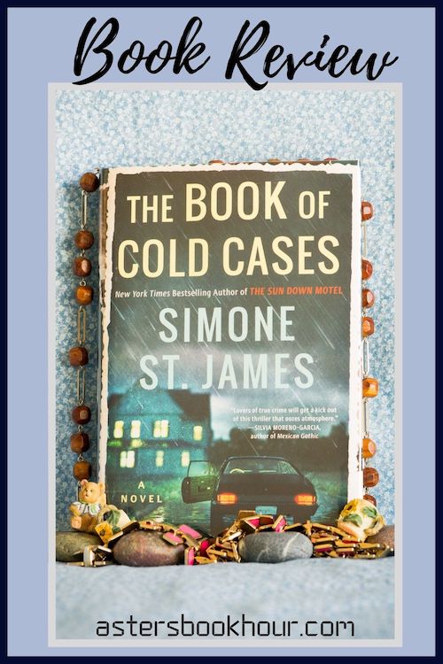 The pinterest image for The Book of Cold Cases by Simone St. James book review. There is a blue floral print background with the novel centered in the middle and the cover facing the front.