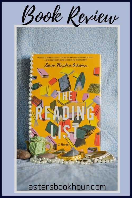 The pinterest image for The Reading List by Sara Nisha Adams book review. There is a blue floral print background with the novel centered in the middle and the cover facing the front.