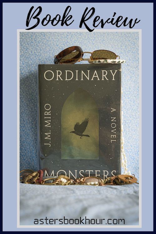 The pinterest image for Ordinary Monsters by J. M. Miro book review. There is a blue floral print background with the novel centered in the middle and the cover facing the front.